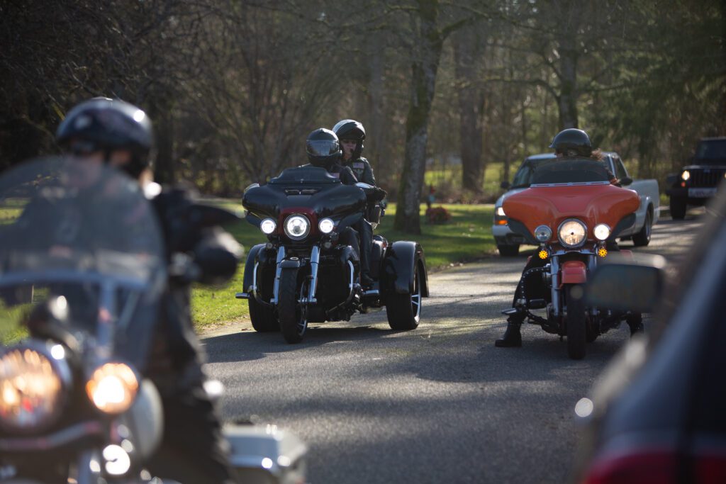 American Legion members on motorcycles escort Helen Luke's ashes to the gravesite ahead of the cars.