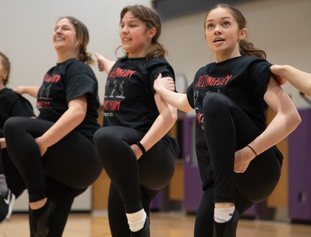 From left, Isabelle Benjamin, Annabelle Schudlich and Sophia Olson-Barrow sync with the same dance move side by side.