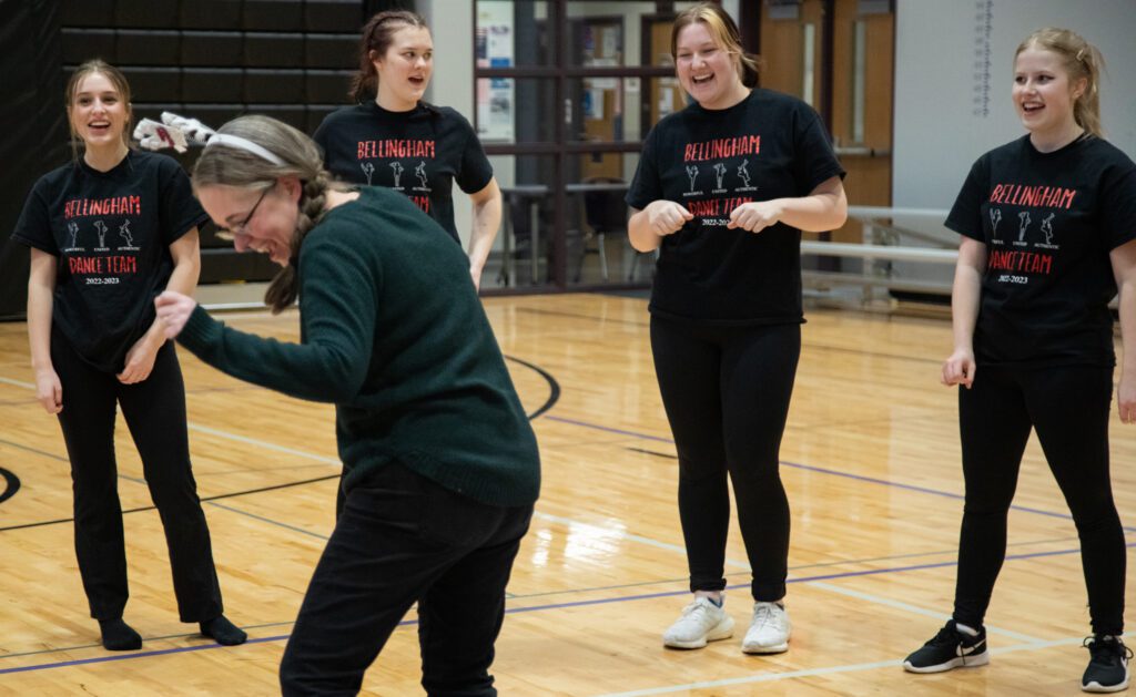 Coach Ronni Weston dances while the Bellingham dance team sings "Happy Birthday" to her.