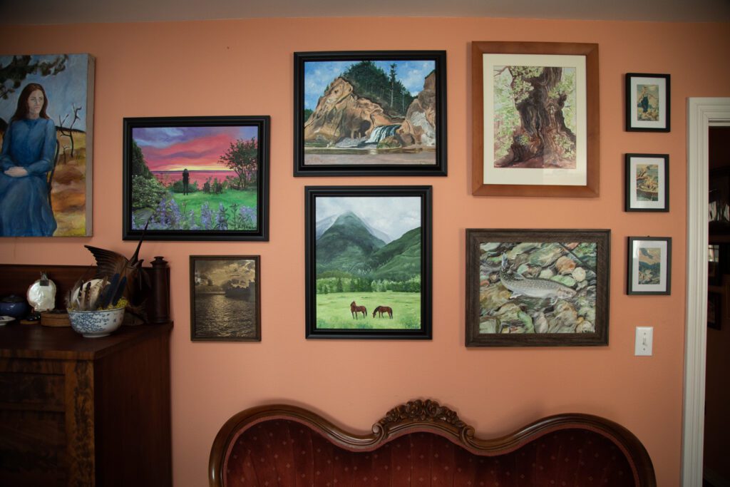 Mason's paintings of various Pacific Northwest scenes hang inside her home.