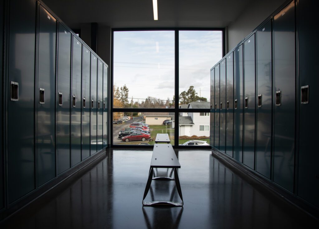 The inside of a locker room at the Operations Center has a large window at the end.