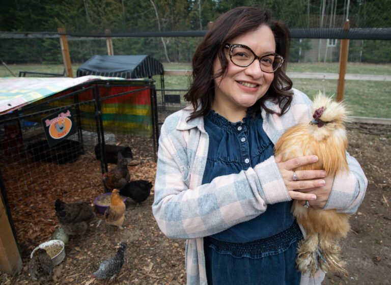 Dalia Monterroso holds Bubbalicious, a fluffy chicken, at the coup.