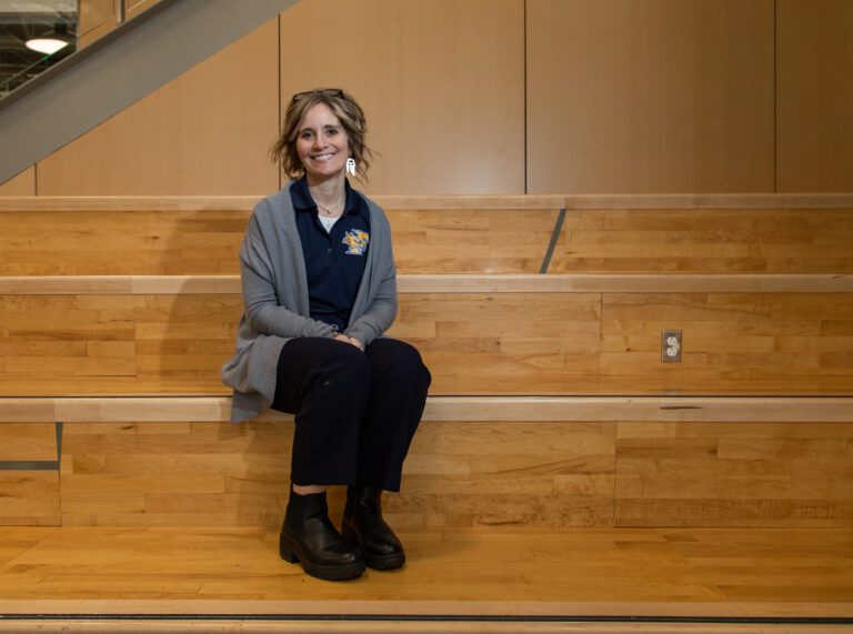 Ferndale School District Superintendent Kristi Dominguez sits on the stairs of the new Ferndale High School commons.