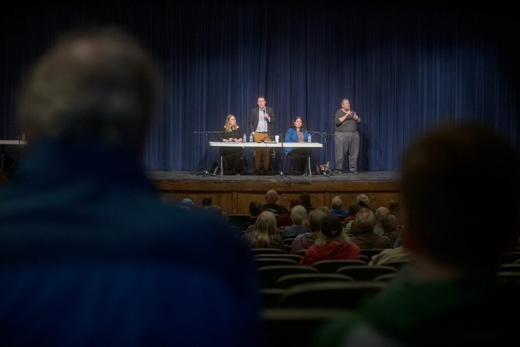 Rep. Alicia Rule, Rep. Joe Timmons and Sen. Sharon Shewmake respond to questions from the stage as audience members listen from the seats.