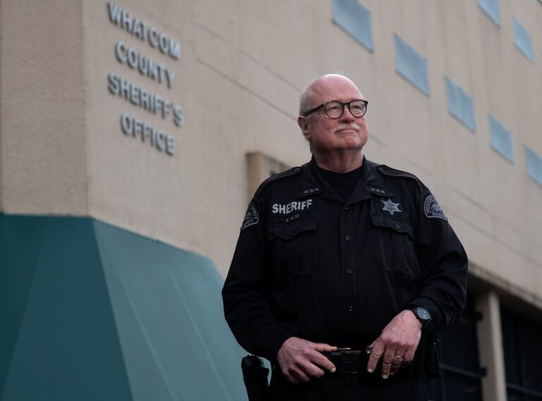 Sheriff Bill Elfo standing in front of Whatcom County Sheriff's office.