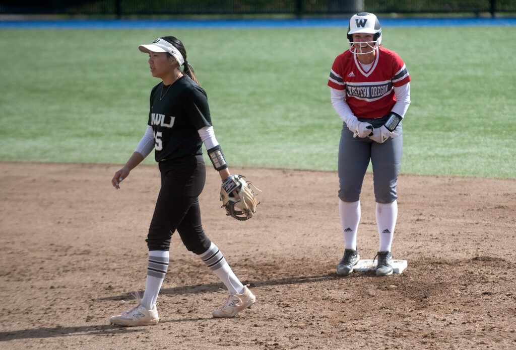 Western Oregon freshman third baseman Sydney Conklin celebrates as another player walks away from the plate.