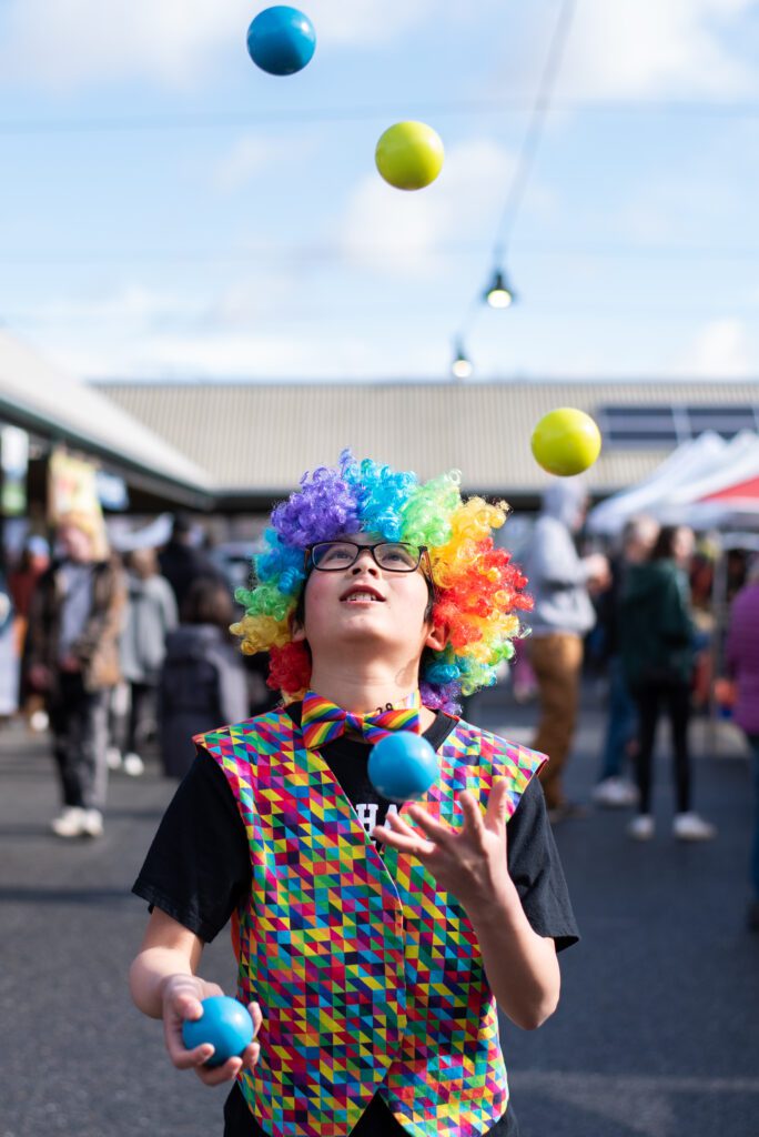 Owen 'The Juggler' keeps his eyes on the balls as he juggles at the Bellingham Farmers Market.