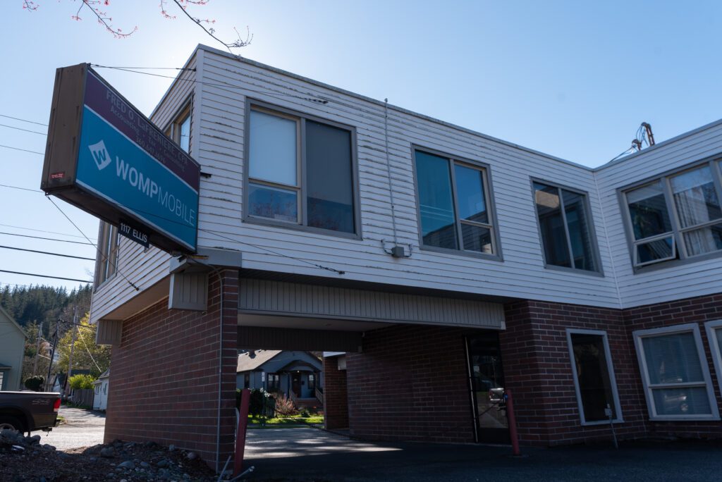 The front entrance of Bellingham's Womp has a bright blue outdoor sign.