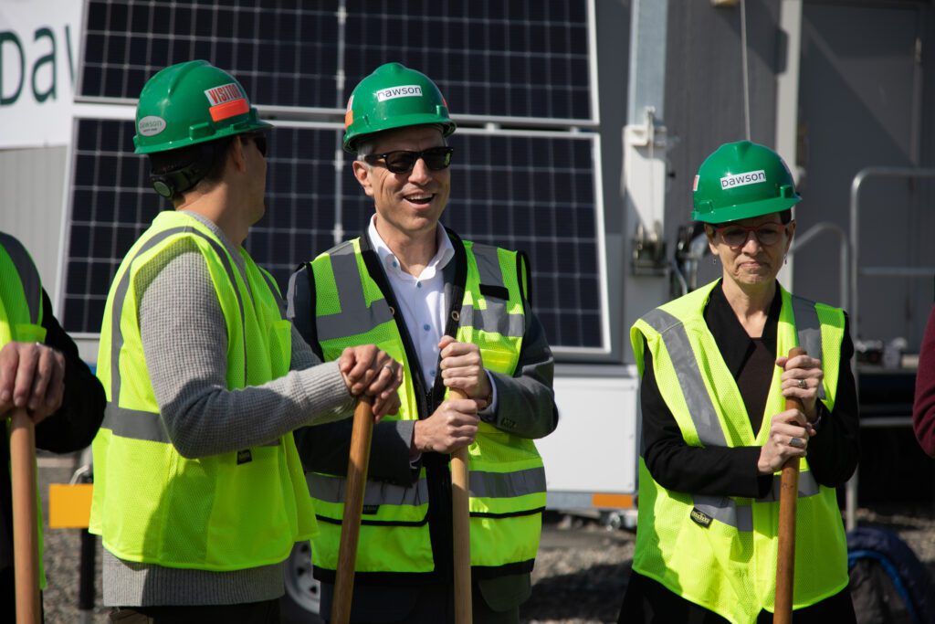 From left, port commissioner Michael Shepard, Mayor Seth Fleetwood and Whatcom Community Foundation President Mauri Ingram don hard hats and vests while leaning onto their shovels.