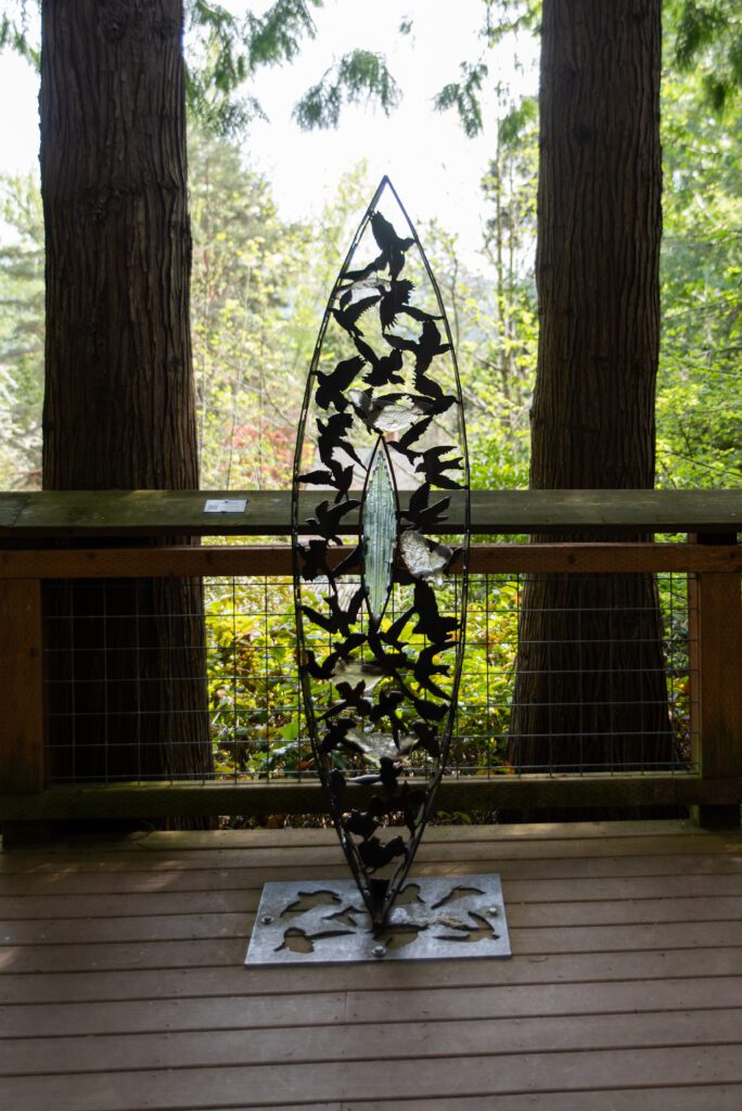 Shirley Erickson's "Positive Spirit" is a metal art piece featuring birds and is on display on a deck at the park.