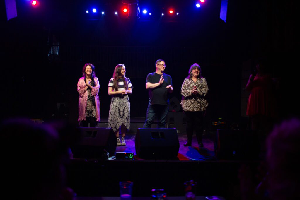 From left, contestants Bobbie Cricket, Em Aagard, Jesse Nussbaum and Tami Miller clap after finding out they're moving to the next round.