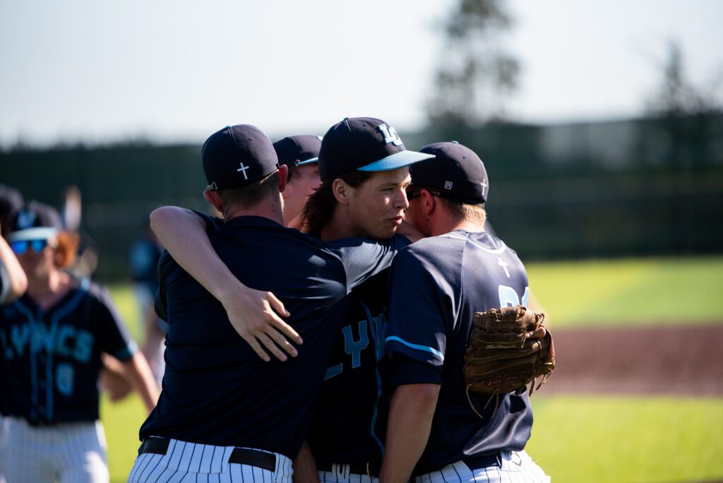 Lynden Christian players hug in a group.