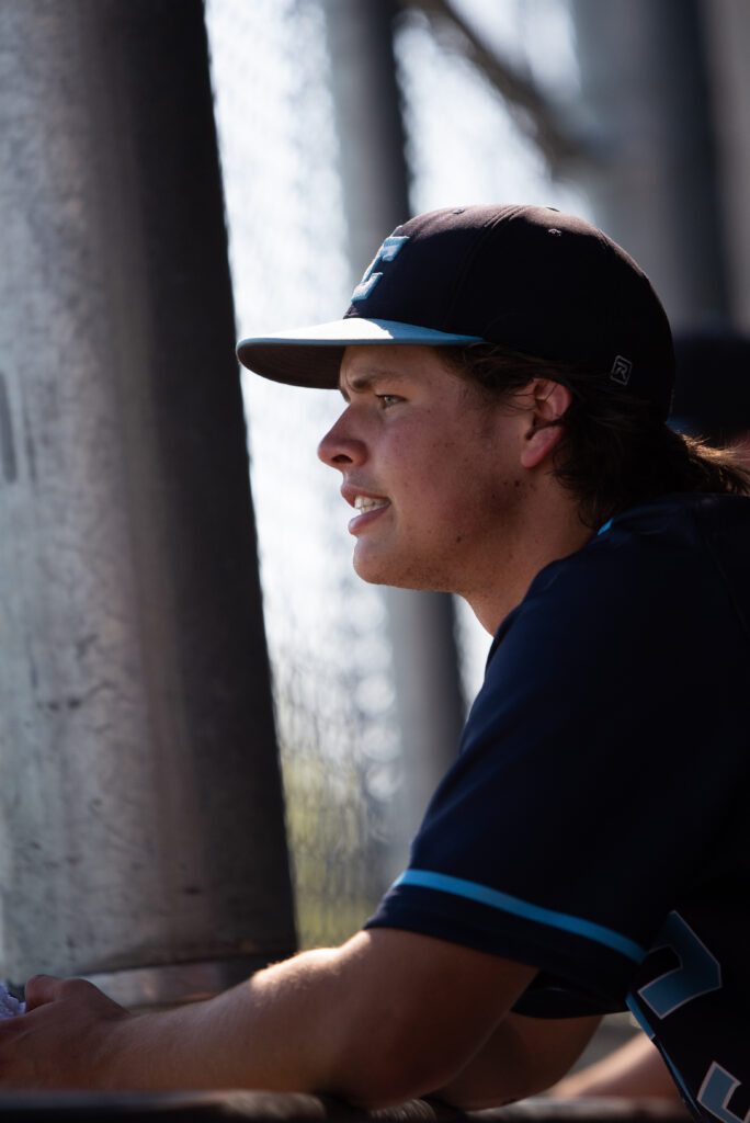 Lynden Christian senior thrid baseman Lane Dykstra looks at the field from the dugout.