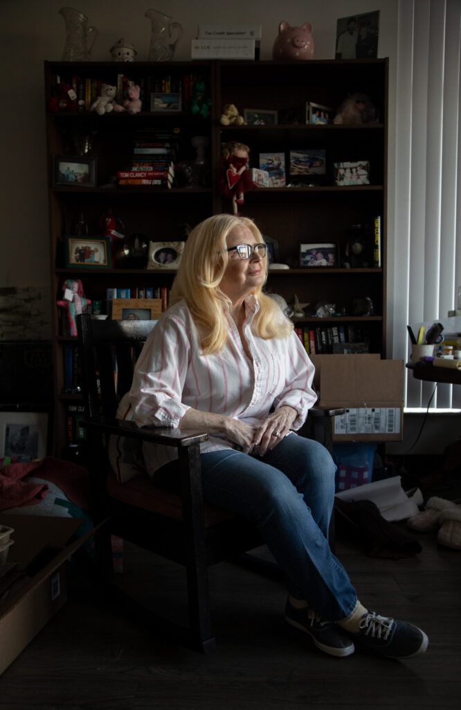 Patty Dawn sits in her apartment as she looks out the window.