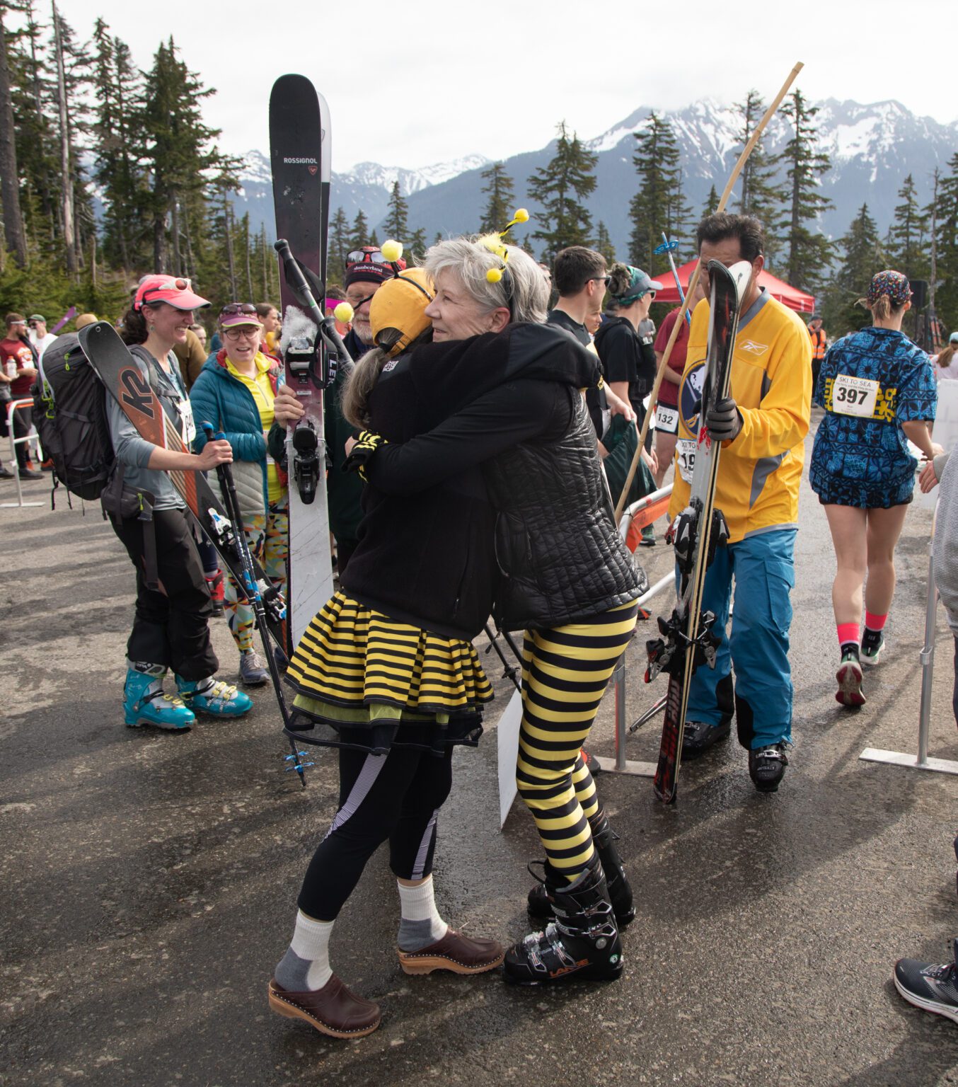 Deb Gordon, left, hugs teammate Becky Brunk of Oldies But New-Bees with both of them dressed in bee-themed outfits.