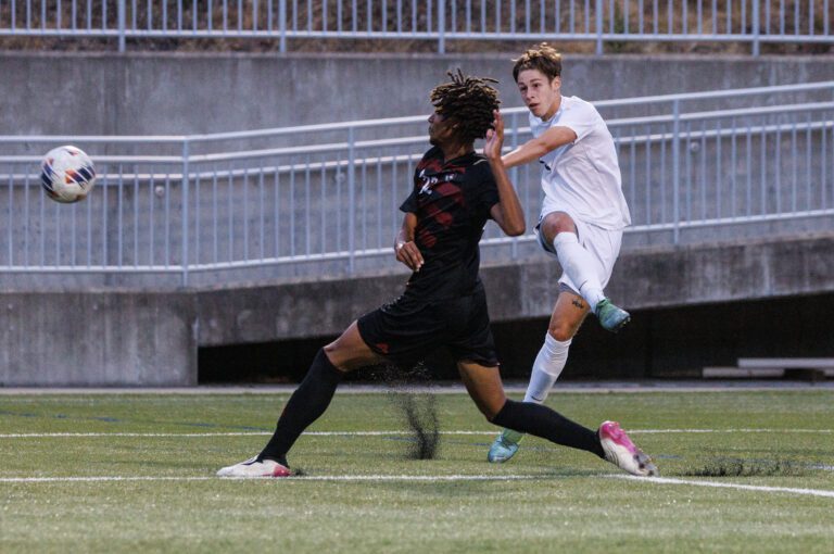 Western Washington University freshman Ryan Rotter kicks the ball past a Chico State defender.