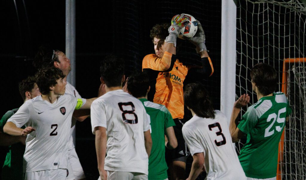 Sehome goalie Kinoah Mitchell grabs the ball on a corner kick.