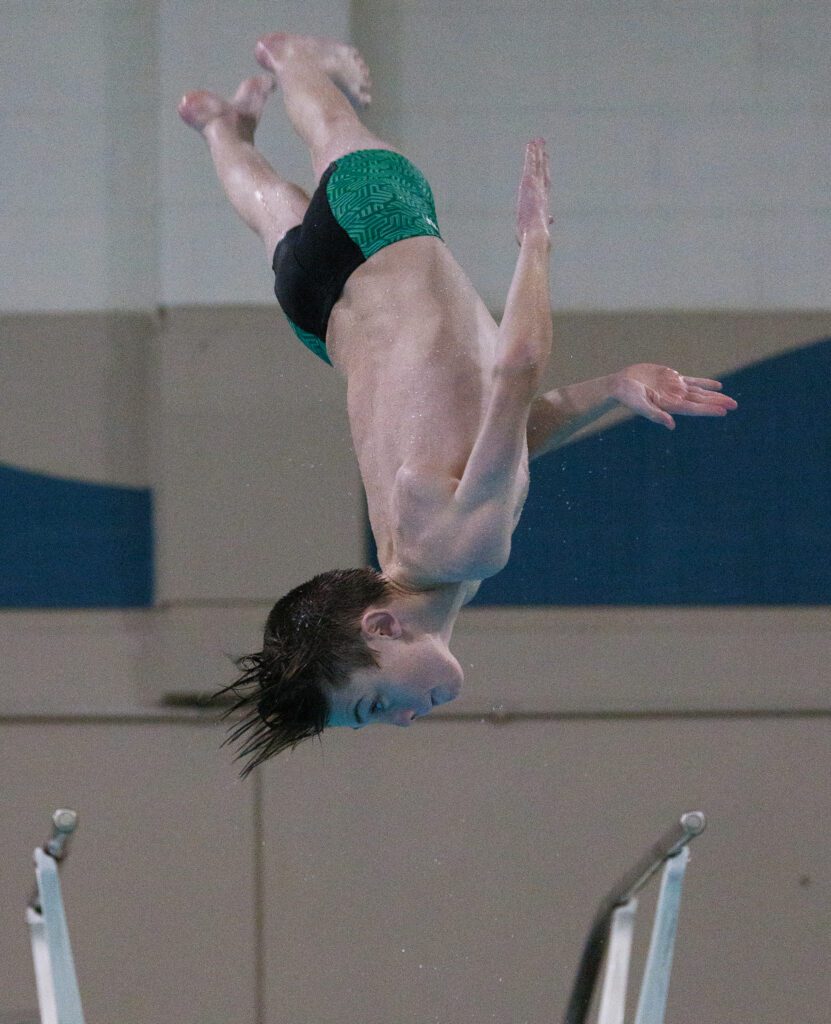 Sehome’s Gus Deluca looks for the landing upside-down while performing a twisting dive.