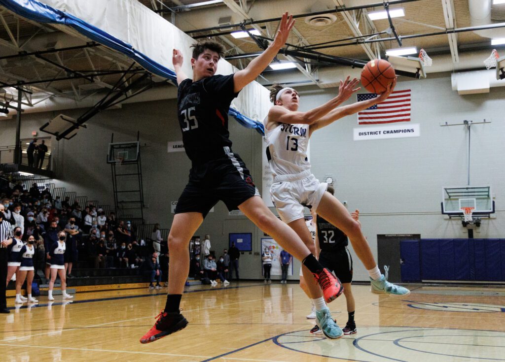 Squalicum's Dylan Jacobs drives around Bellingham's Henry Sheldrup for a shot.