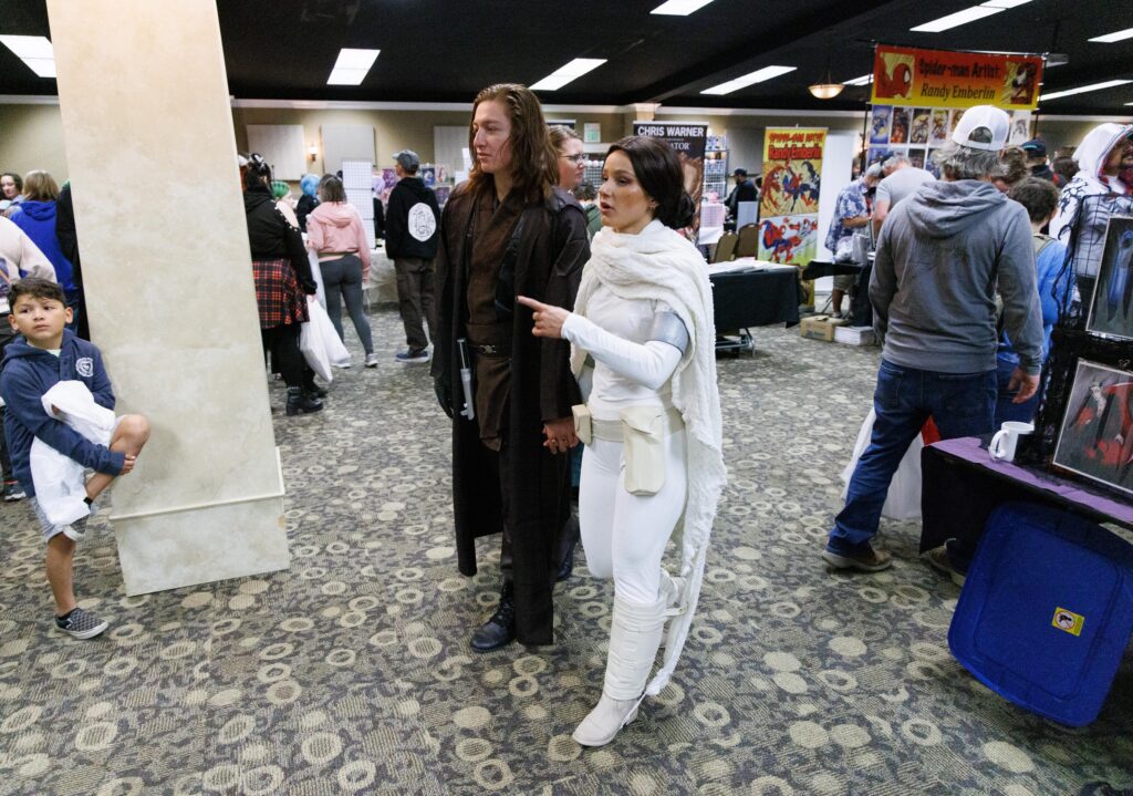 Alex Farias and Hayley James hold hands as they wander the Bellingham Comicon as Anakin Skywalker and Padme from Star Wars.