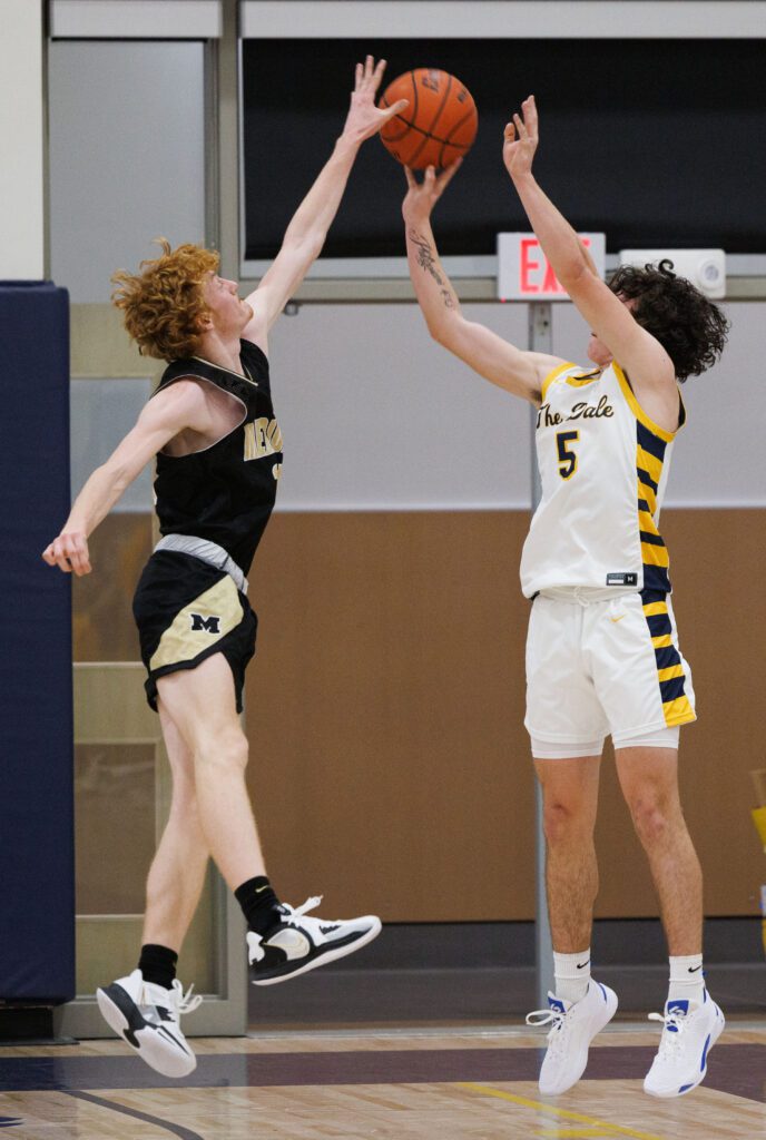 Meridian's Hunter Jones gets a hand on a shot made by Ferndale's Lincoln Thomas.