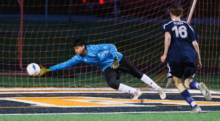 Meridian's Alejandro Santana nearly gets a hand on the ball as he dives to the side.