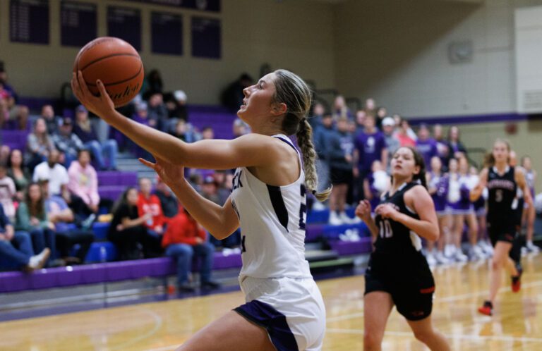 Nooksack Valley’s Devin Coppinger rolls the ball while looking up to the basket.