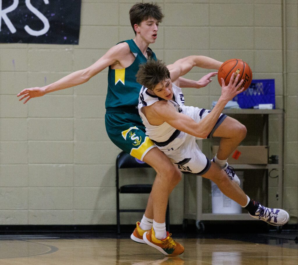 Sehome's Grey Garrison falls onto Nooksack Valley's Dawson Kimball.