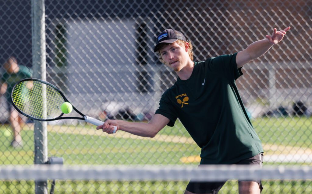 Sehome’s Nathan Gruman reaches for the ball with his racket.