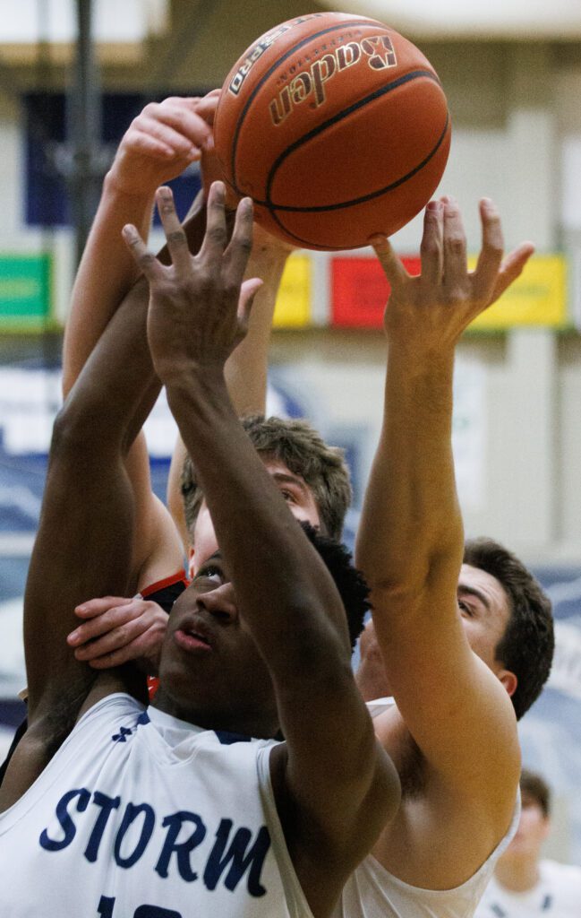 Squalicum’s Marcus Nixon battles for a rebound while under pressure from a defender.