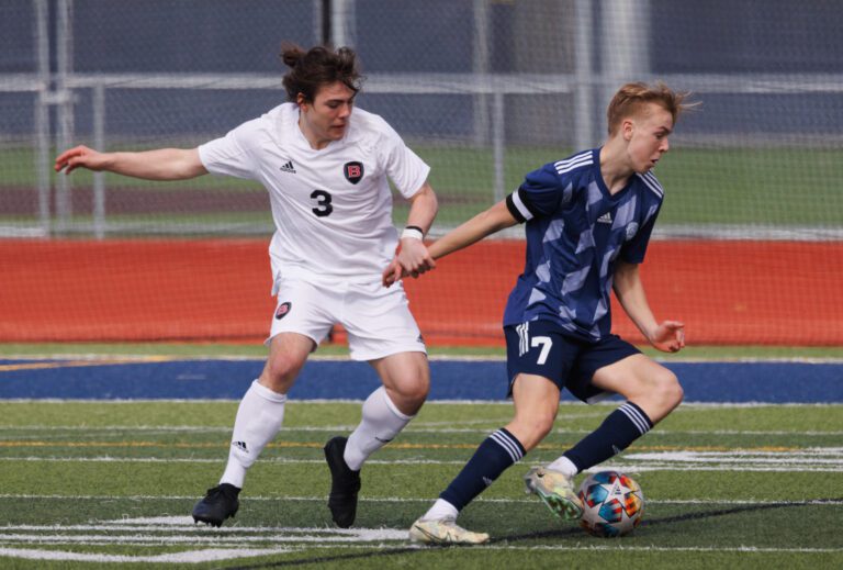 Lorenzo Pellecchia tries to hold back Xander Koenig as he steers the ball away.