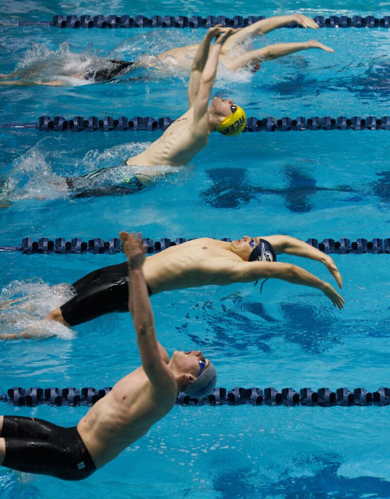 Squalicum’s Mathias Synnott dives backwards with their arms pointed to the waters.