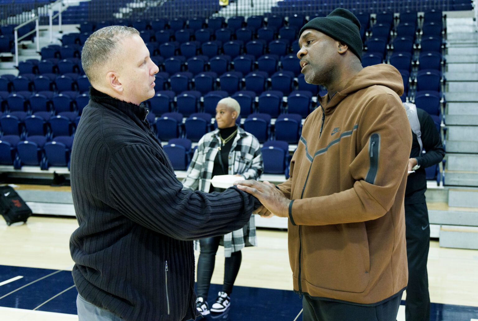 Lincoln University men's basketball coach Gary Payton, a former Seattle SuperSonics player, takes time to share a personal talk with Western Washington University head coach Tony Dominquez.