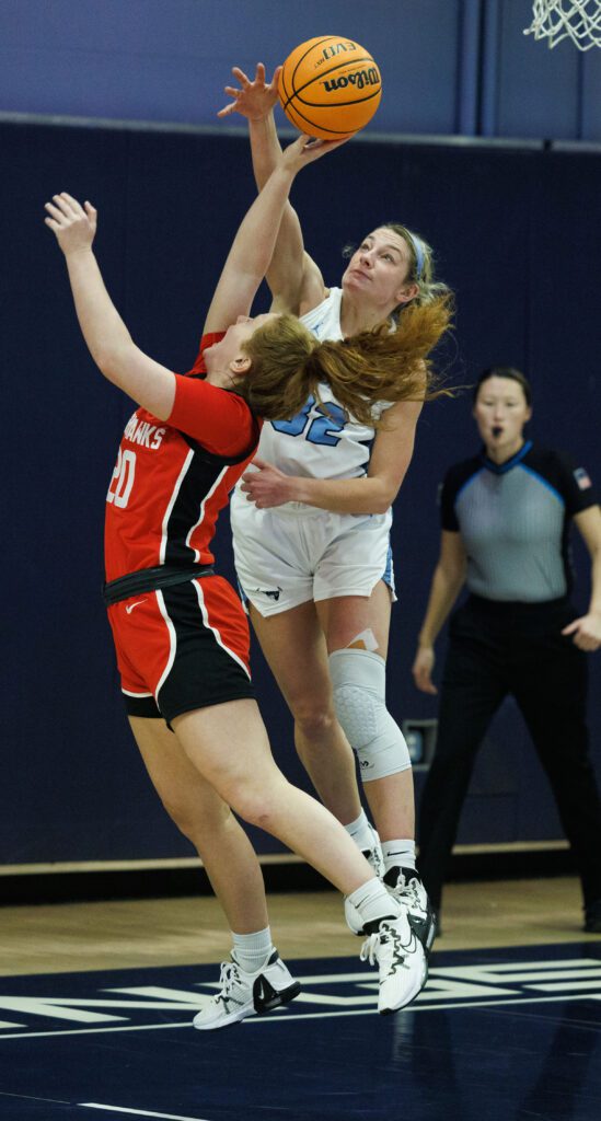 Western’s Mollie Olson tries to reach over Northwest Nazarene University's Cami Knishka.