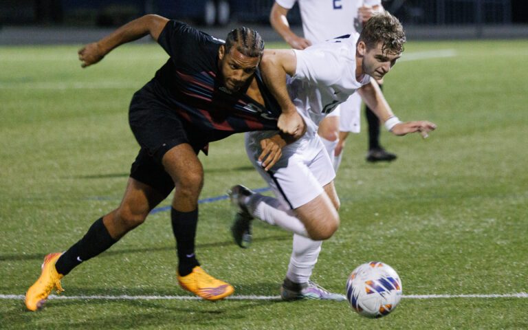 Western Washington University’s Eric Bunnell tangles with a Chico State defender as they battle for the ball.