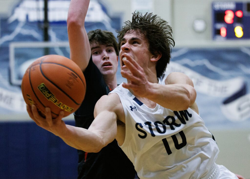 Squalicum's Leyton Smithson drives to the basket while under pressure from a defender.