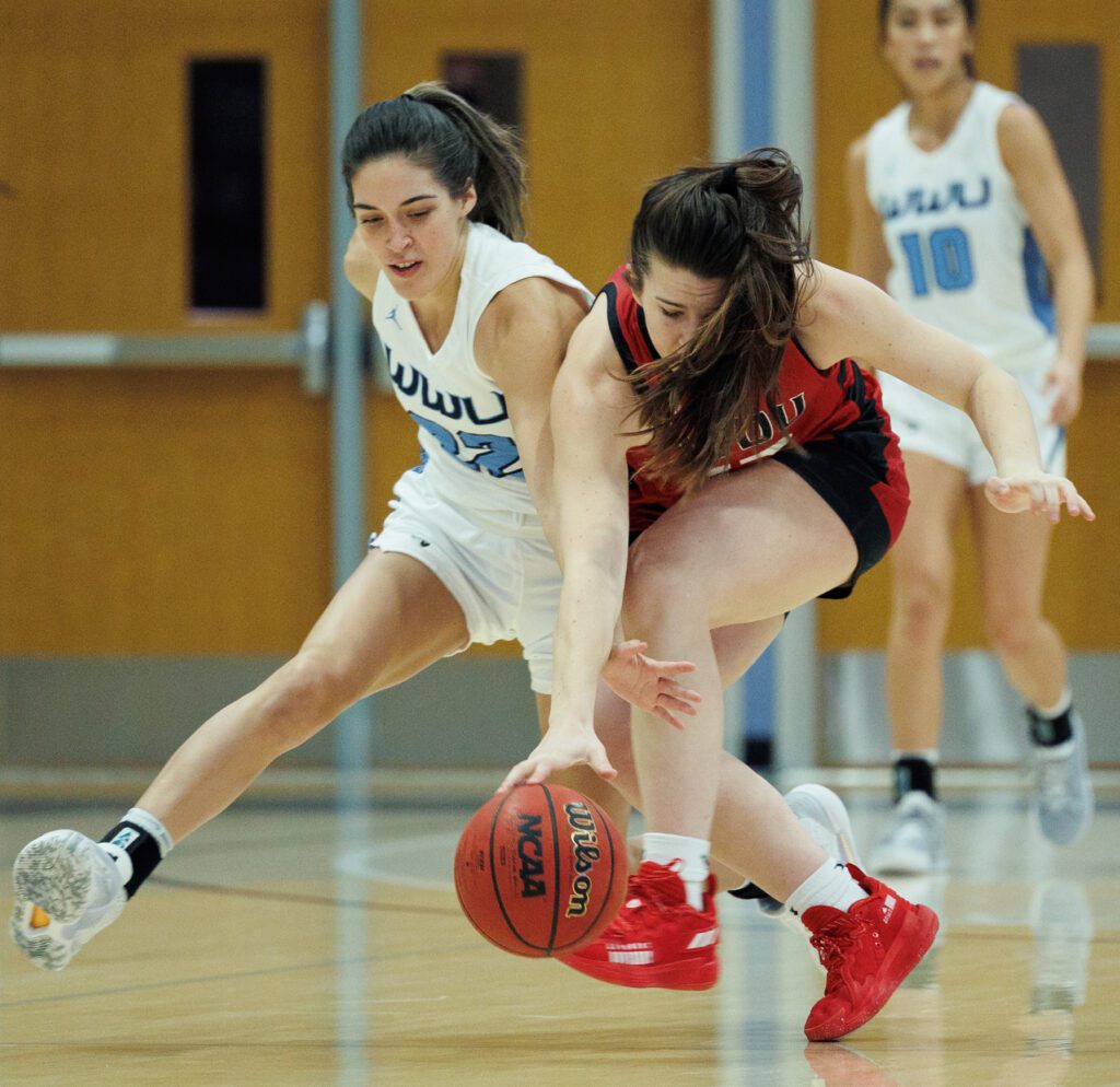 Western Washington University’s Gracie Castaneda, left, fights for the loose ball.