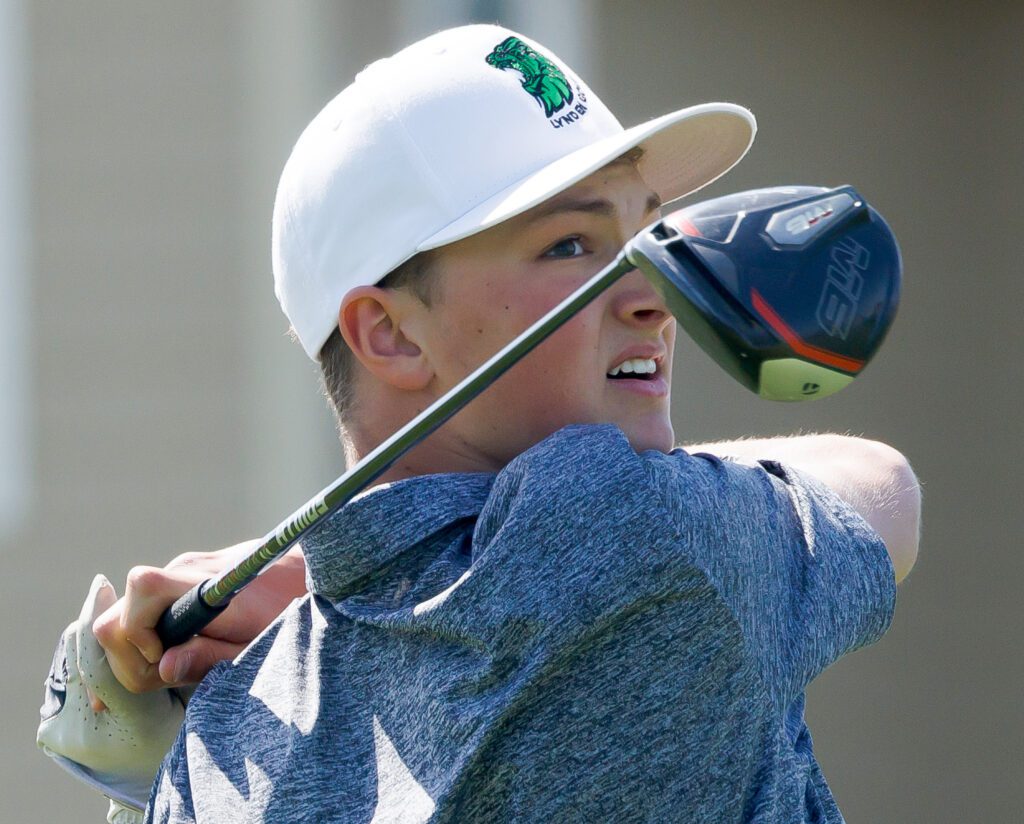 Lynden's Jack Stapleton watches his tee shot with his golf club held over his shoulders.