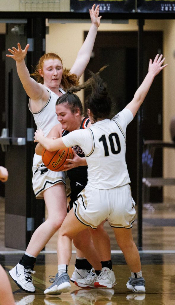 Meridian's Skyleigh James and Emilee Swanson pressure Blaine's Alia Ball.