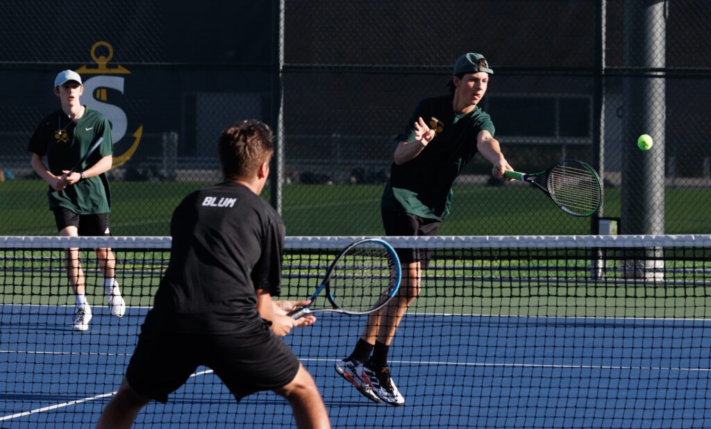 Sehome’s Whitt Gresham returns a shot during a doubles match with teammate Calvin Kraynak.