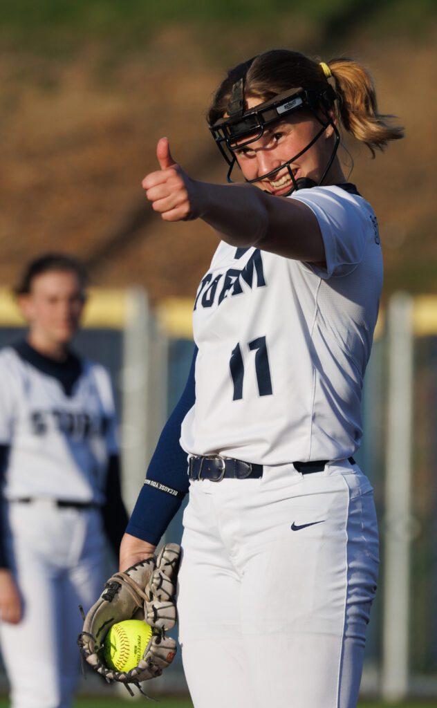 Squalicum's Regan Andersen gives a third baseman an enthusiastic thumbs up with a smile.