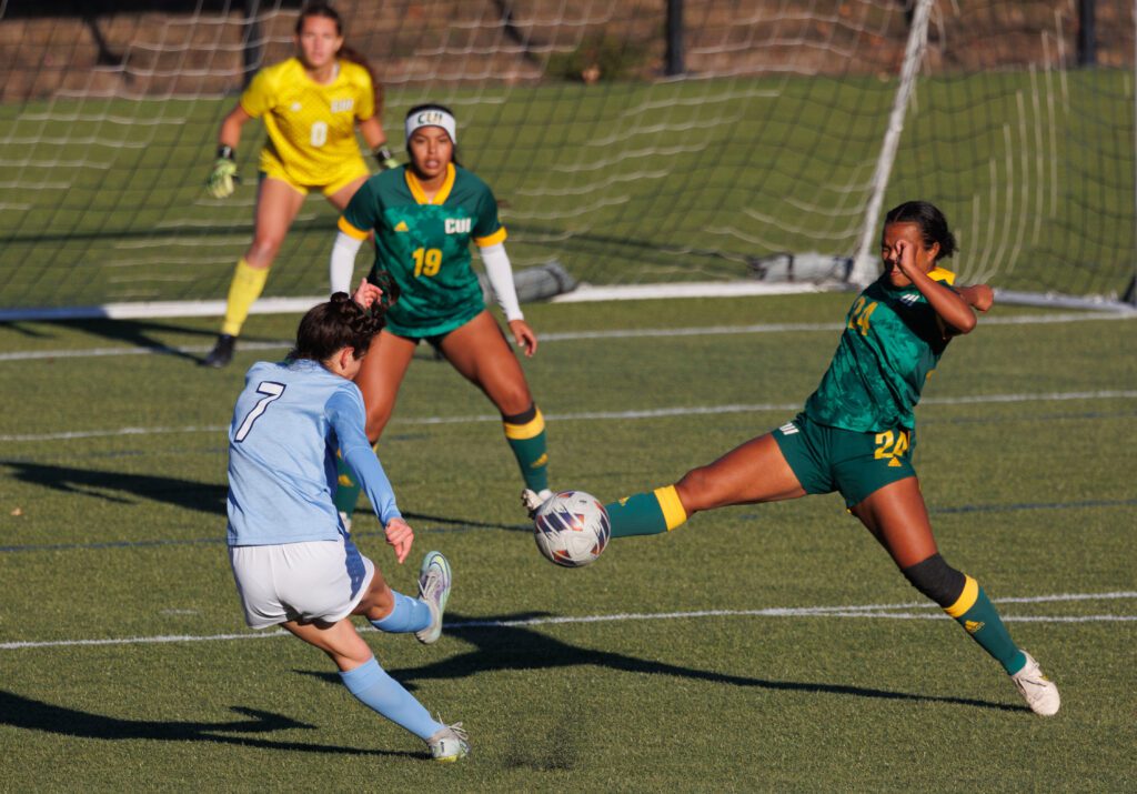 Western Washington University's Dayana Diaz full sends it on a ball as a defender blocks the path.