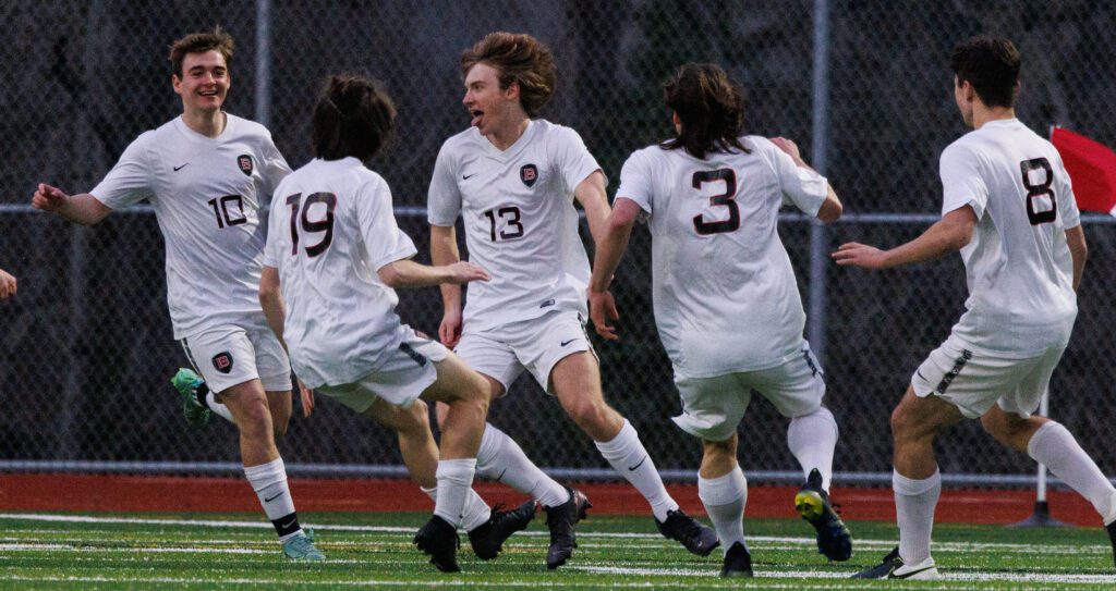 Bellingham's Kaden Potts (13) celebrates an early goal with his teammates.