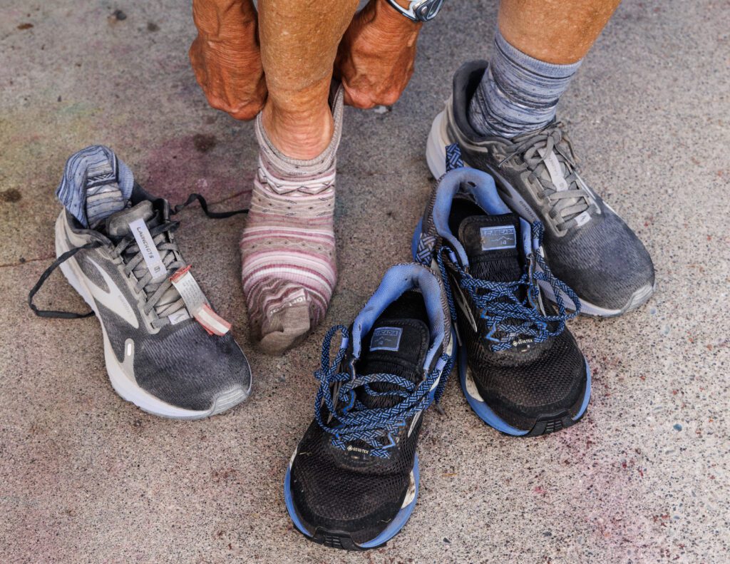 A runner changes socks and shoes.