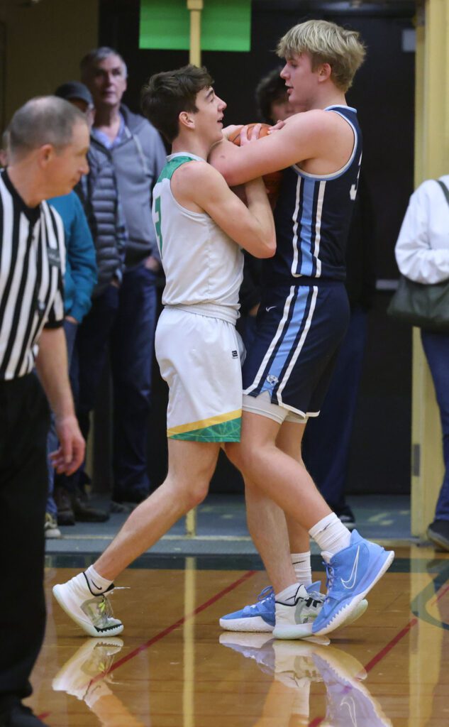 Lynden’s Coston "Bubba" Parcher and Lynden Christian’s Jeremiah Wright fight for control of the ball that is stuck between them.