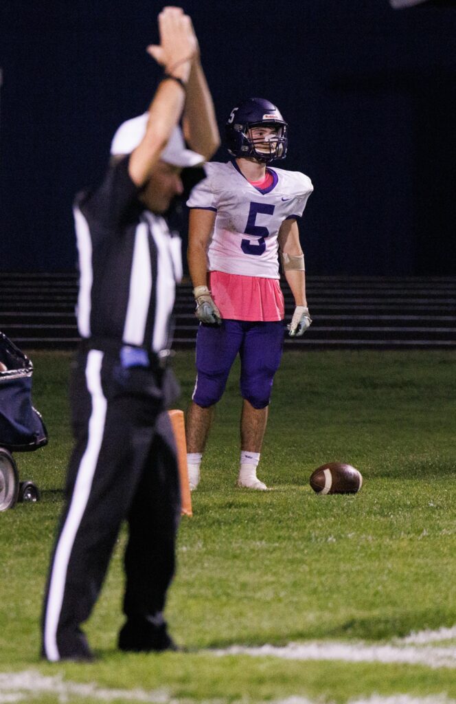 Nooksack Valley's Skyler Whittern stands in the back of the end zone as a referee signals with both hands.