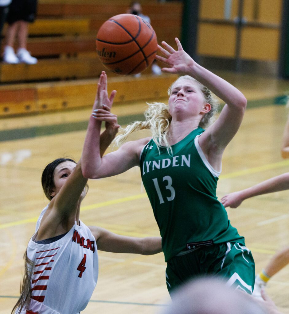 Lynden's Adia Newcomb is fouled hard as she tries to drive past defenders.