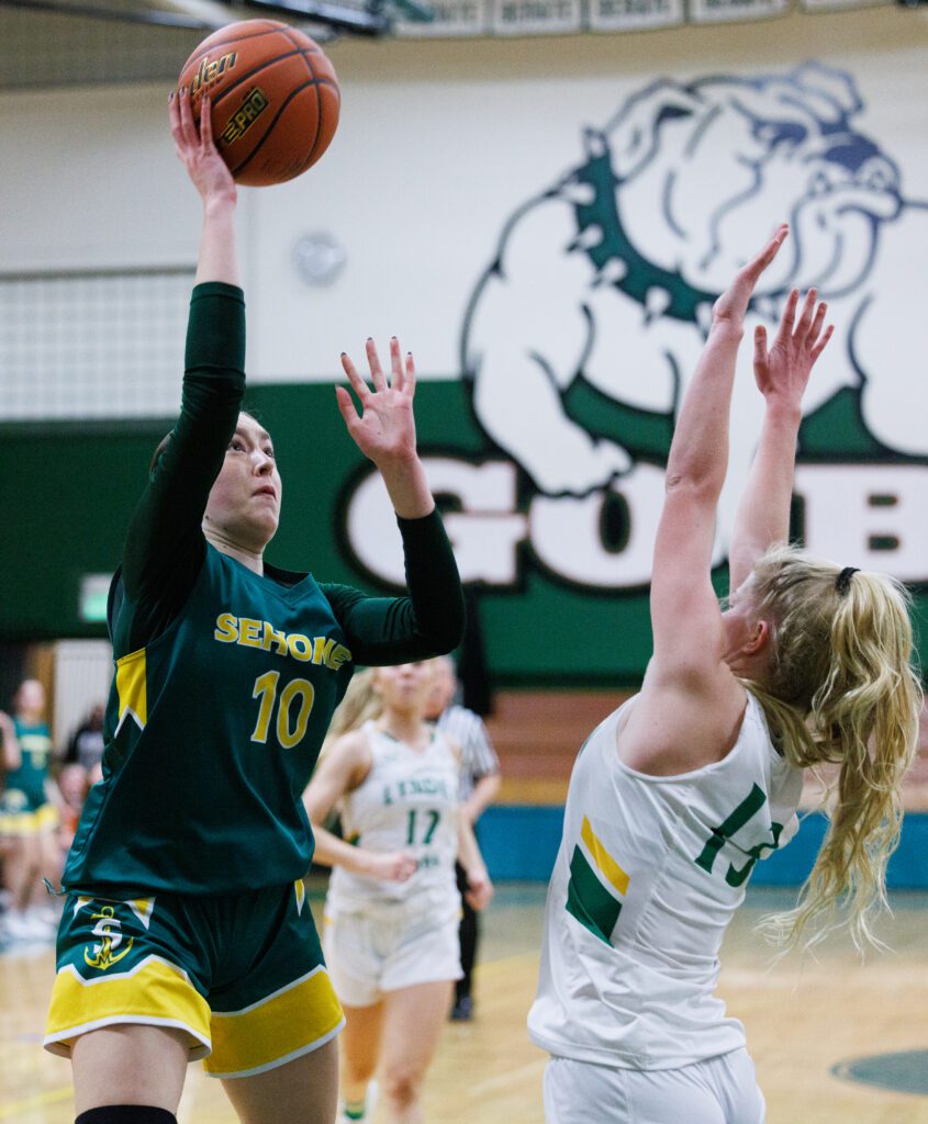 Sehome's Madeline Schumacher shoots over Lynden's Adia Newcomb.