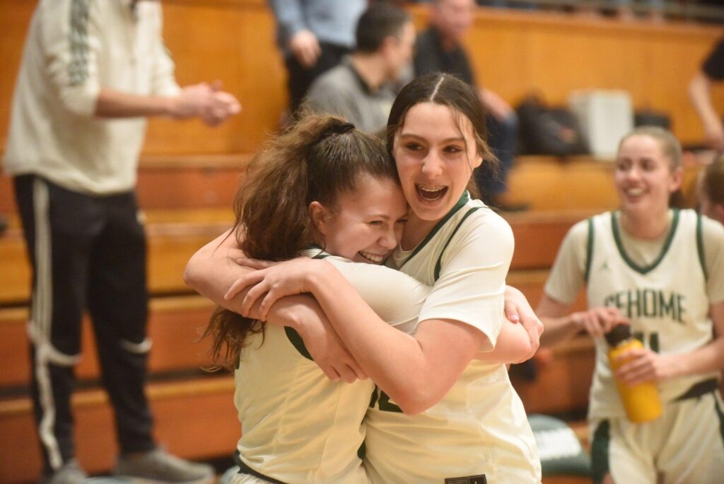 Two Sehome players hug in celebration.