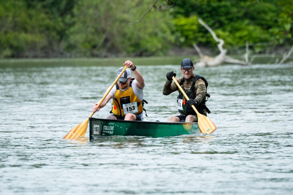 Heath Sowers, front, and Walker Capra-Smith power through the canoe leg with their wooden paddles.